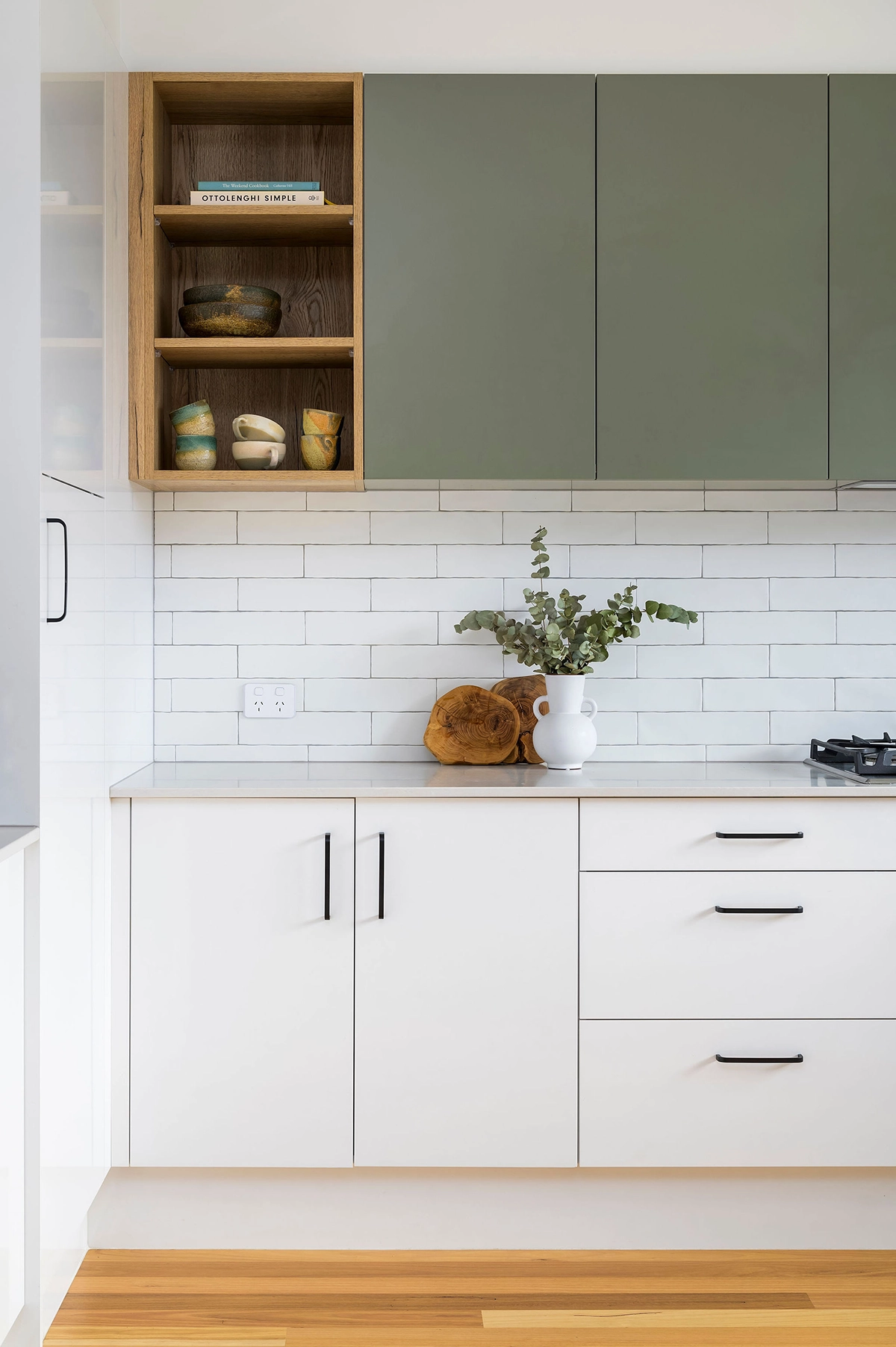 white kitchen with green cabinets